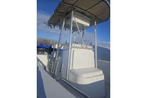 Slide: The Image of 2004 Sea Pro 220 Center Console boat with T-top under clear blue sky. - 7