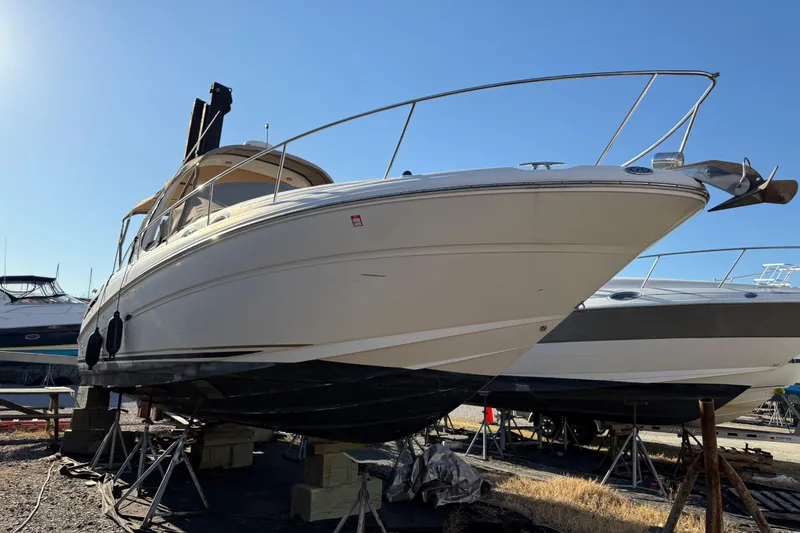 Slide: The Image of 2003 Sea Ray 300 Sundancer boat on dry dock, side view. - 1