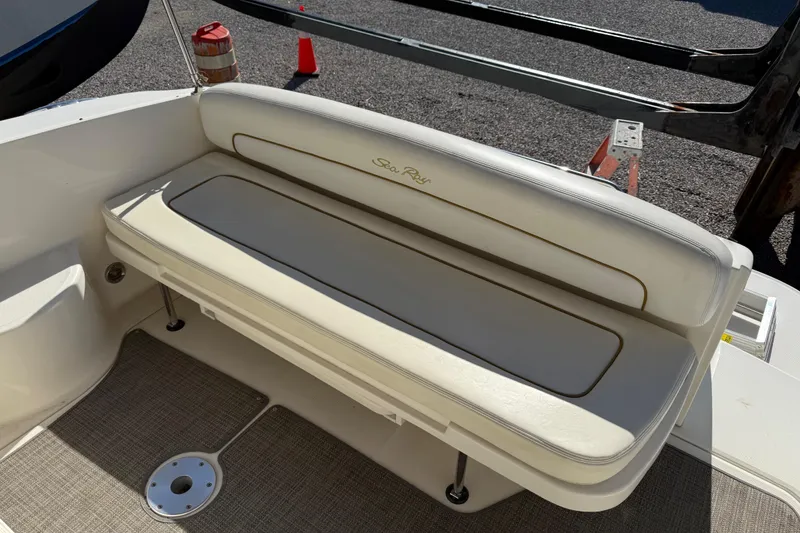 Slide: The Image of 2003 Sea Ray 300 Sundancer boat seating area with beige upholstery. - 16