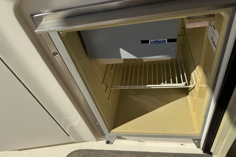 Slide: The Image of Open Isotherm fridge on 2003 Sea Ray 300 Sundancer boat, showing empty interior. - 17