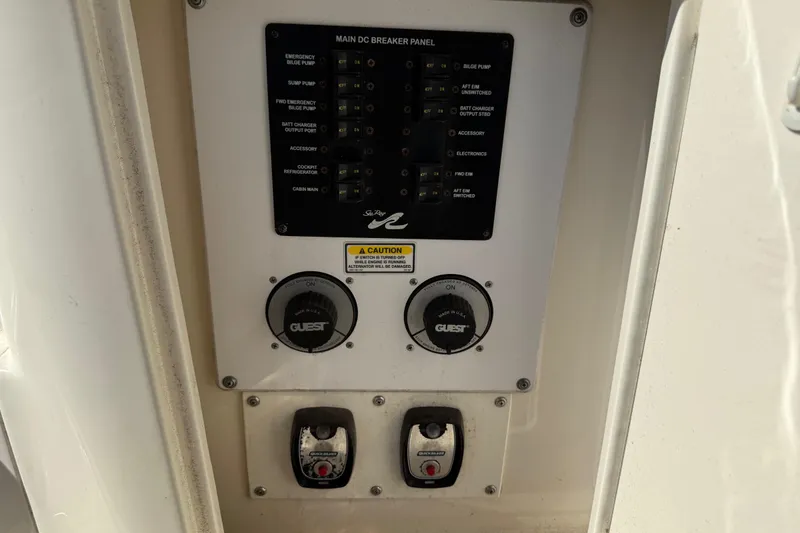 Slide: The Image of Control panel of a 2003 Sea Ray 300 Sundancer boat with switches and dials. - 18
