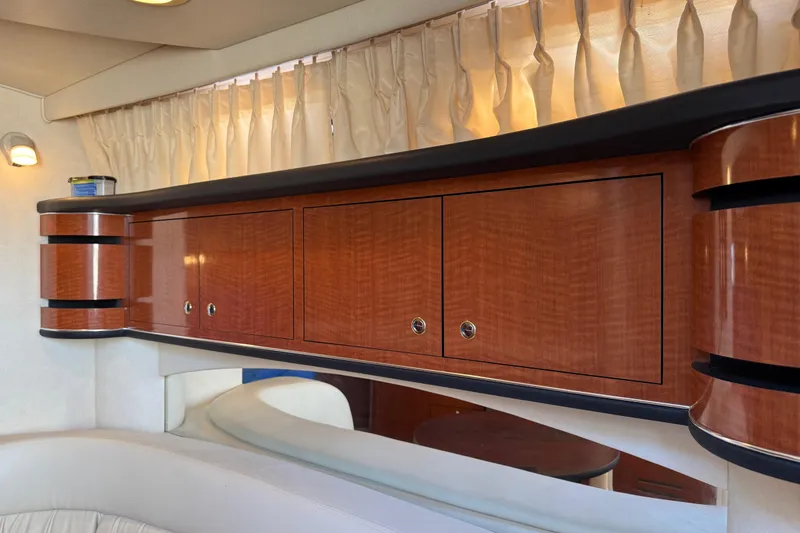 Slide: The Image of Interior of 2003 Sea Ray 300 Sundancer with elegant wooden cabinetry and soft lighting. - 24