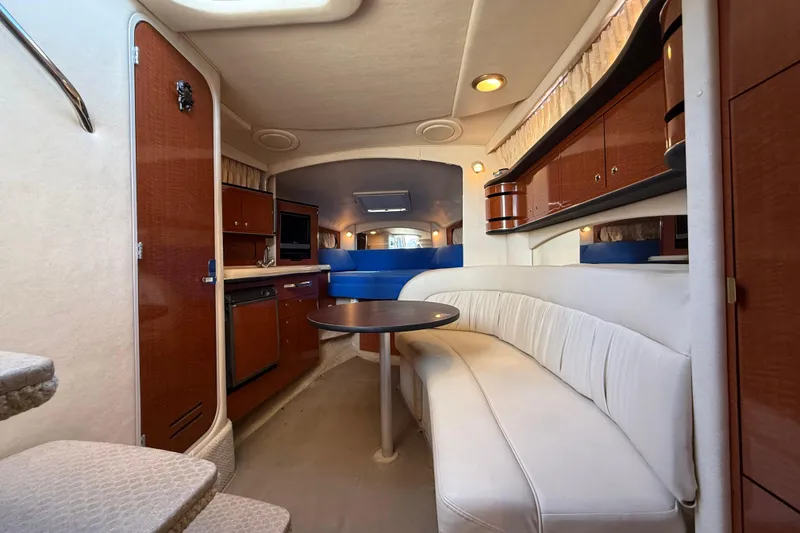Slide: The Image of Interior of 2003 Sea Ray 300 Sundancer yacht with cozy seating and kitchenette. - 28