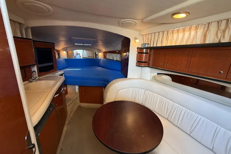 Slide: The Image of Interior of 2003 Sea Ray 300 Sundancer yacht with cozy seating and kitchenette. - 30