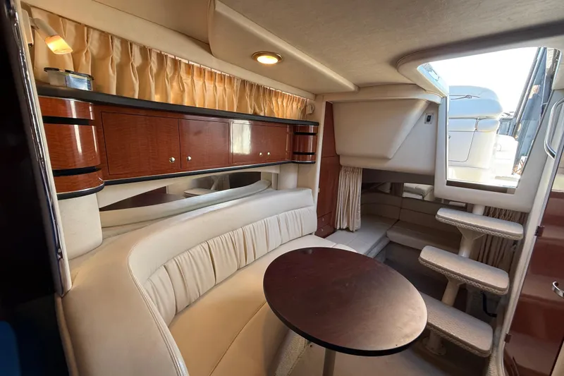 Slide: The Image of Luxurious interior of 2003 Sea Ray 300 Sundancer yacht with elegant seating and wooden cabinetry. - 31