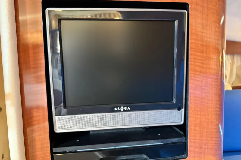 Slide: The Image of Insignia TV mounted on 2003 Sea Ray 300 Sundancer yacht's wooden interior. - 36