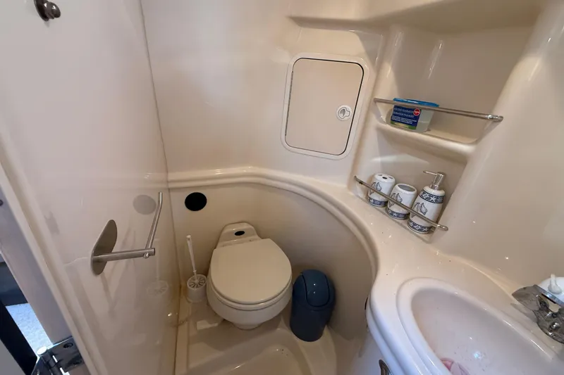 Slide: The Image of Bathroom interior of 2003 Sea Ray 300 Sundancer yacht, featuring toilet and sink. - 38