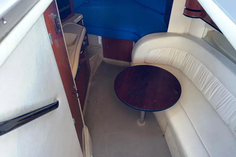 Slide: The Image of 2003 Sea Ray 300 Sundancer cabin interior with seating and table. - 42