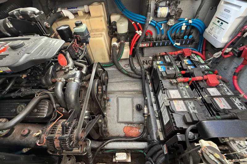 Slide: The Image of Engine compartment of a 2003 Sea Ray 300 Sundancer with visible batteries and wiring. - 45