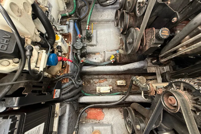 Slide: The Image of Engine compartment of a 2003 Sea Ray 300 Sundancer, showing belts and hoses. - 46