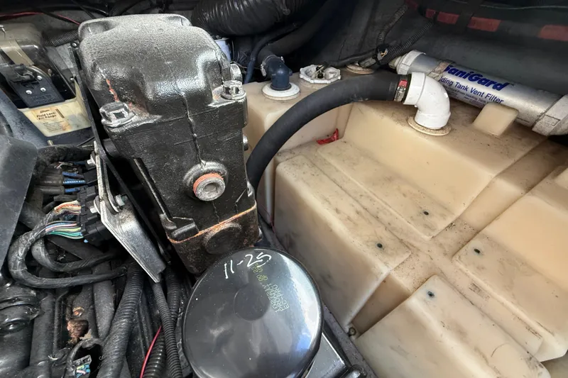 Slide: The Image of Engine compartment of a 2003 Sea Ray 300 Sundancer boat, showing components and wiring. - 48