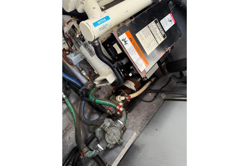 Slide: The Image of Engine compartment of 2003 Sea Ray 300 Sundancer with visible wiring and components. - 51