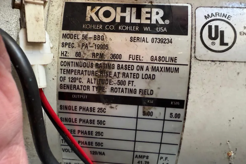 Slide: The Image of Kohler marine generator label on a 2003 Sea Ray 300 Sundancer, model 5E-BBG, gasoline-powered. - 52
