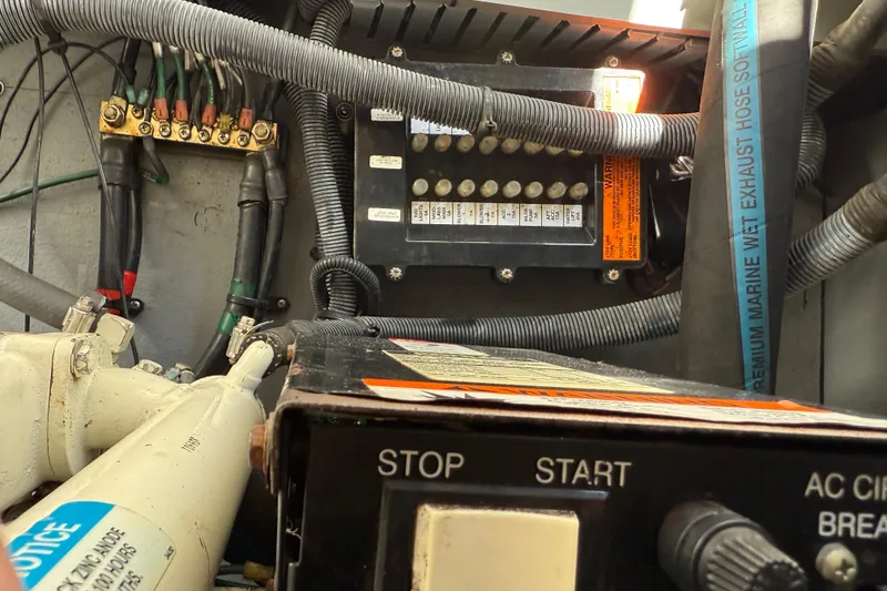 Slide: The Image of Engine compartment of 2003 Sea Ray 300 Sundancer, showing wiring and control panel. - 53