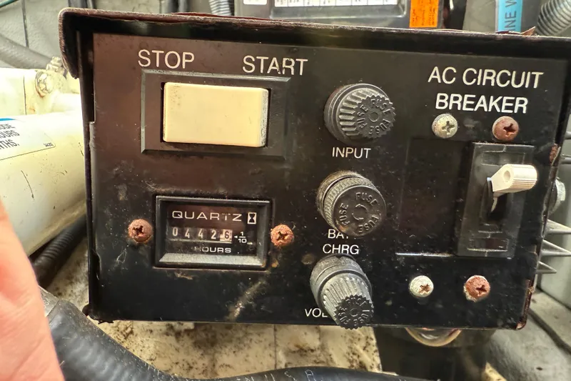 Slide: The Image of Control panel of a 2003 Sea Ray 300 Sundancer boat with hour meter and circuit breaker. - 54