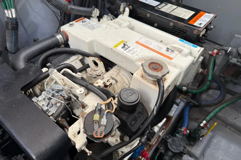 Slide: The Image of Engine compartment of a 2003 Sea Ray 300 Sundancer boat, showing detailed components and wiring. - 55