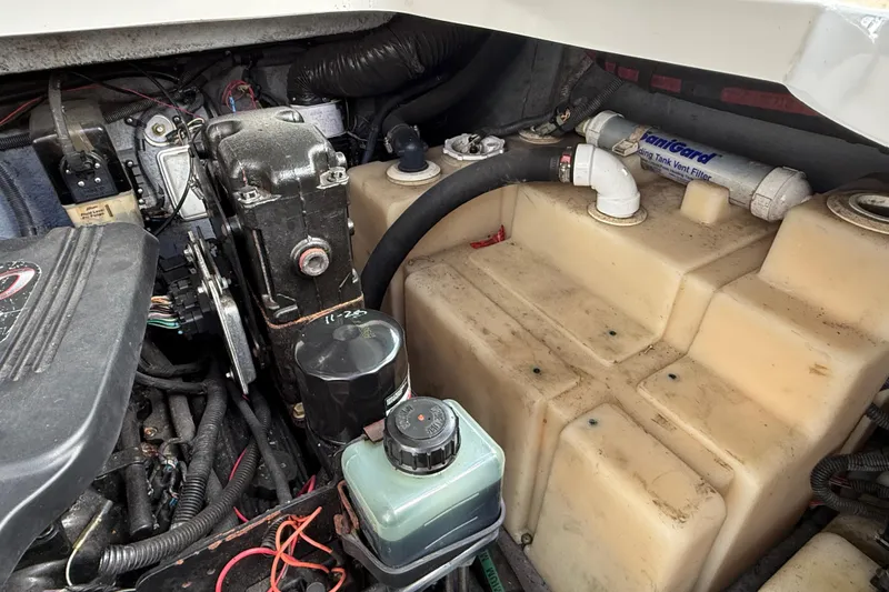 Slide: The Image of Engine compartment of a 2003 Sea Ray 300 Sundancer boat, showing mechanical components. - 57