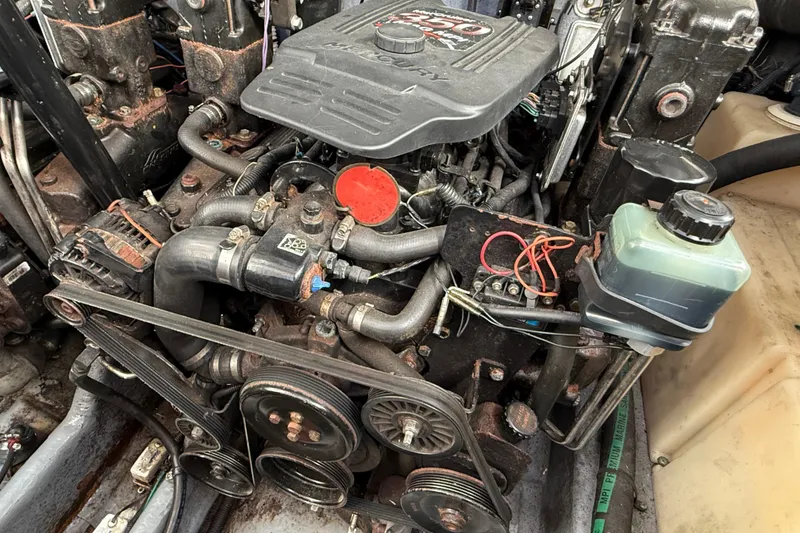 Slide: The Image of Engine of a 2003 Sea Ray 300 Sundancer boat, showcasing mechanical components. - 58