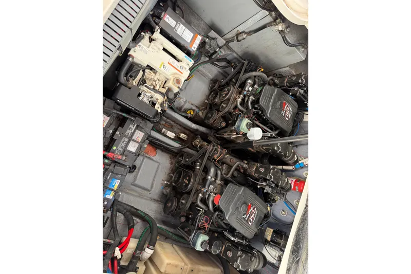 Slide: The Image of Engine compartment of a 2003 Sea Ray 300 Sundancer boat, showcasing dual engines. - 59