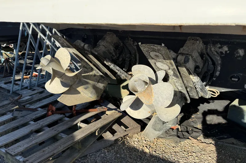 Slide: The Image of Propellers of a 2003 Sea Ray 300 Sundancer boat on a wooden pallet. - 61