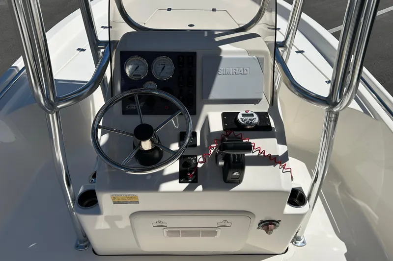 Slide: The Image of 2021 Bulls Bay 2200 boat console with steering wheel and Simrad navigation system. - 10