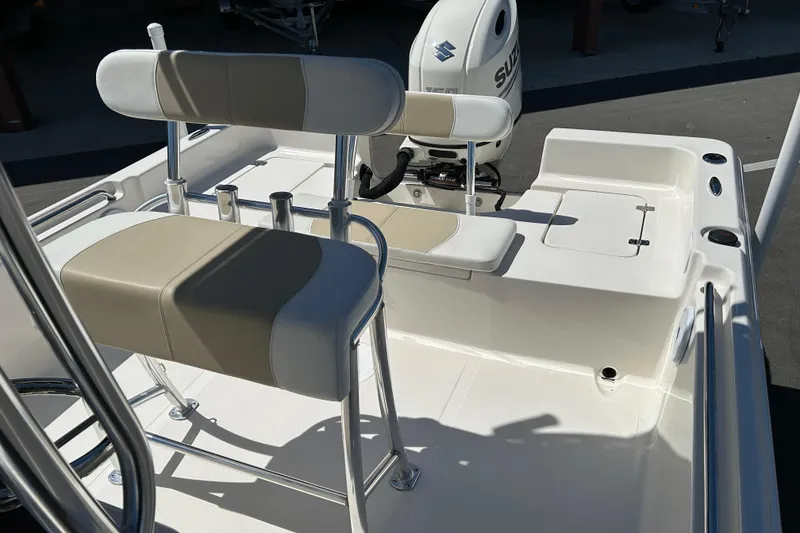 Slide: The Image of 2021 Bulls Bay 2200 boat interior with seating and Suzuki outboard motor. - 11