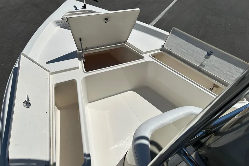 Slide: The Image of 2021 Bulls Bay 2200 boat storage compartments open on deck. - 14
