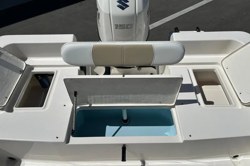 Slide: The Image of 2021 Bulls Bay 2200 boat interior with storage compartments and Suzuki 150 engine. - 16