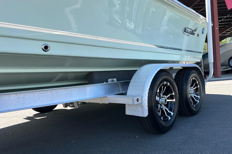 Slide: The Image of 2021 Bulls Bay 2200 boat on a dual-axle trailer, close-up view. - 17