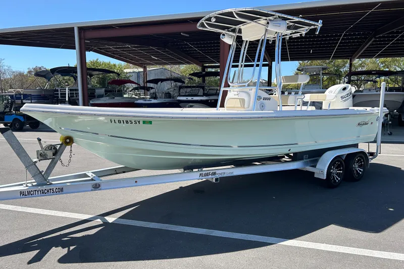 Slide: The Image of 2021 Bulls Bay 2200 boat on trailer at dealership, featuring Suzuki engine. - 5
