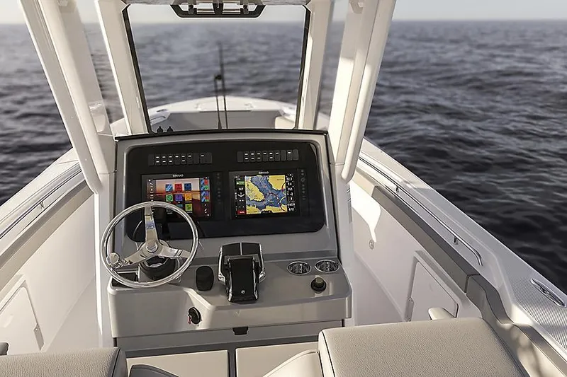 Slide: The Image of Manufacturer Provided Image: 2026 Boston Whaler 290 Outrage helm with advanced navigation system on open sea. - 2