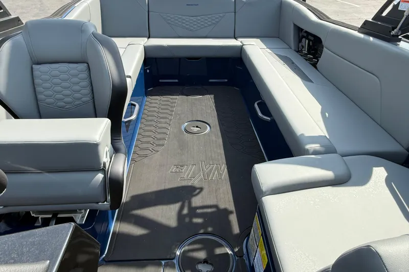Slide: The Image of 2026 MasterCraft NXT24 boat interior with gray seating and sleek design. - 3