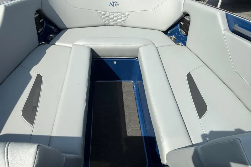 Slide: The Image of Interior seating of 2026 MasterCraft NXT24 boat, featuring sleek gray upholstery. - 4