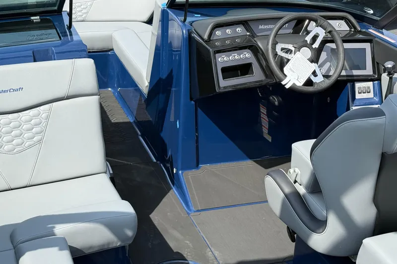 Slide: The Image of 2026 MasterCraft NXT24 boat interior with modern dashboard and comfortable seating. - 7