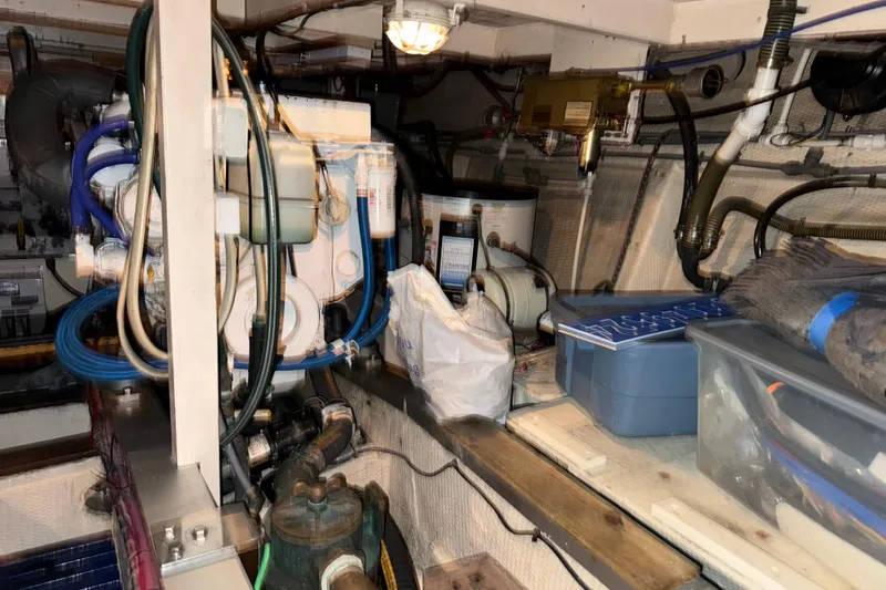 Slide: The Image of Engine room of 1991 Grand Banks 42 Classic with equipment and storage containers. - 107