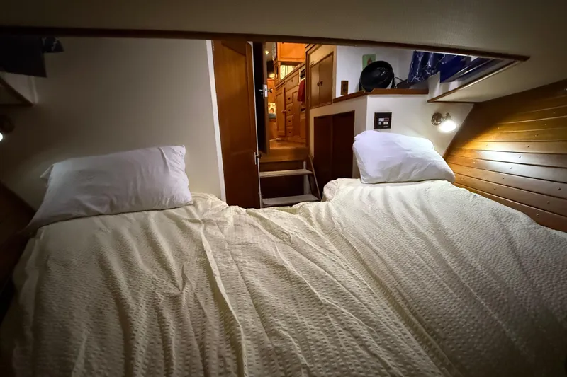 Slide: The Image of Cozy cabin interior of 1991 Grand Banks 42 Classic yacht with twin beds and wooden paneling. - 70