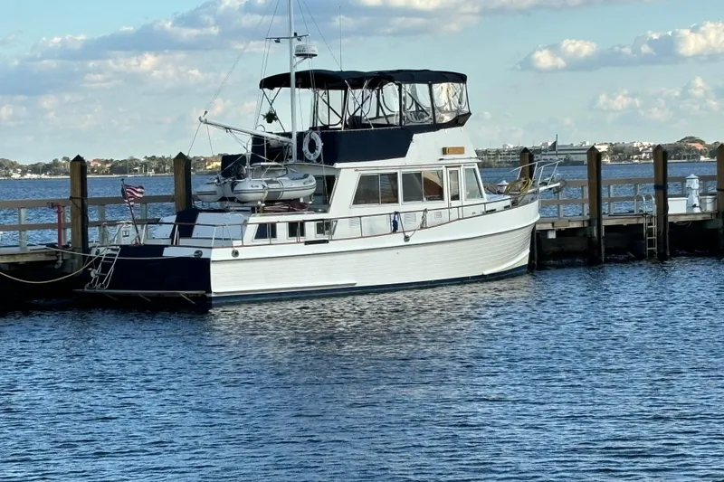 Slide: The Image of 1991 Grand Banks 42 Classic yacht docked by the pier on a sunny day. - 6