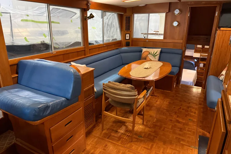 Slide: The Image of Interior of 1991 Grand Banks 42 Classic yacht with blue seating and wooden furnishings. - 12