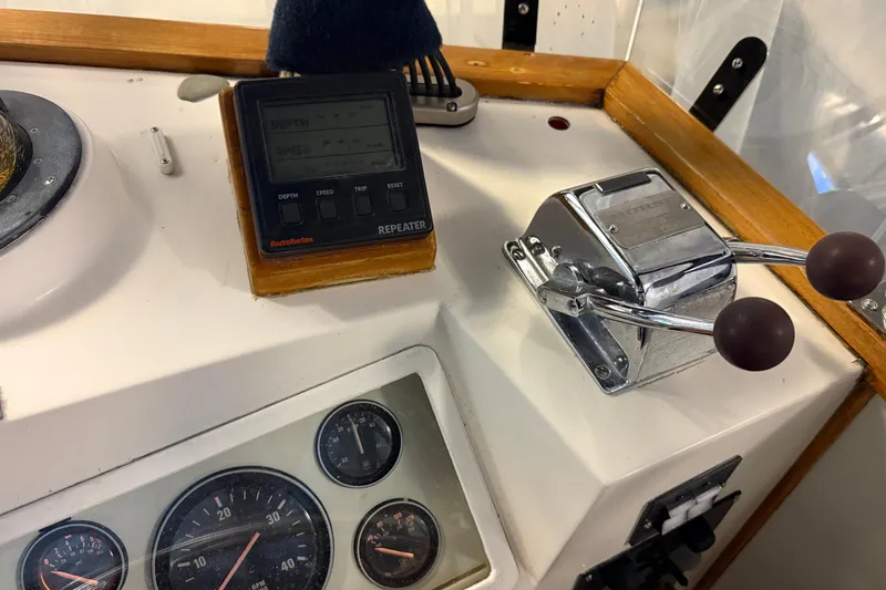 Slide: The Image of 1991 Grand Banks 42 Classic helm with gauges, throttle, and Autopilot repeater. - 88