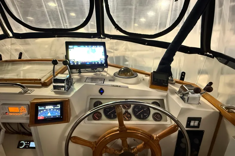 Slide: The Image of Helm of 1991 Grand Banks 42 Classic with navigation equipment and wooden steering wheel. - 85