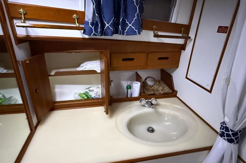 Slide: The Image of Bathroom vanity on 1991 Grand Banks 42 Classic yacht with sink, mirror, and storage. - 75