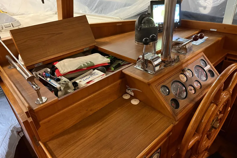 Slide: The Image of 1991 Grand Banks 42 Classic helm with wooden dashboard, gauges, and navigation equipment. - 35