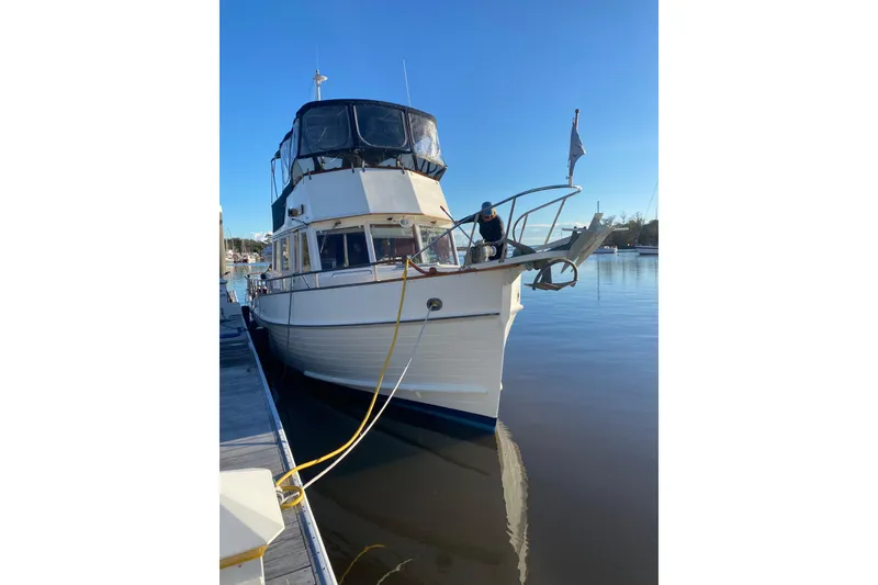 Slide: The Image of 1991 Grand Banks 42 Classic yacht docked at marina under clear blue sky. - 7