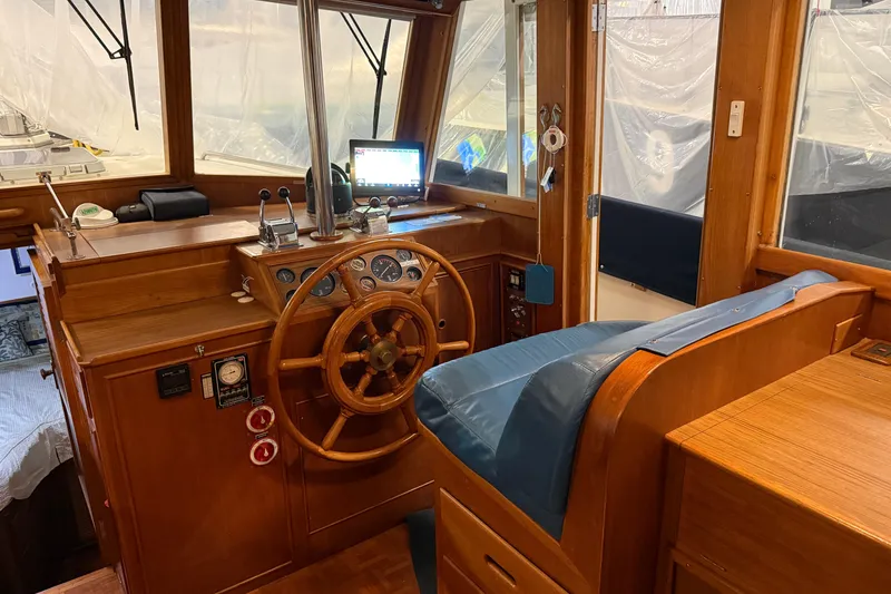 Slide: The Image of 1991 Grand Banks 42 Classic yacht helm with wooden wheel and navigation equipment. - 33