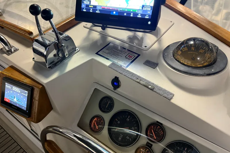 Slide: The Image of Helm of 1991 Grand Banks 42 Classic with navigation instruments and controls. - 87