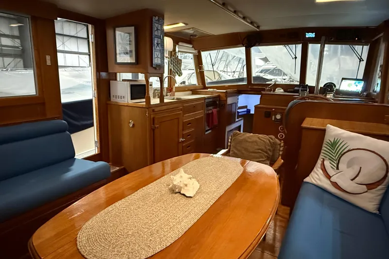 Slide: The Image of Interior of 1991 Grand Banks 42 Classic yacht with wooden furnishings and cozy seating. - 15