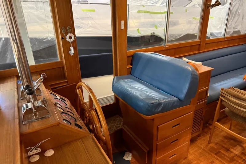 Slide: The Image of Interior of 1991 Grand Banks 42 Classic yacht with wooden helm and blue seating. - 32