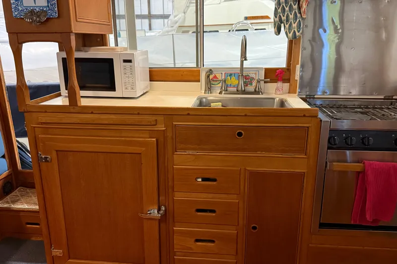 Slide: The Image of Galley kitchen in 1991 Grand Banks 42 Classic yacht with wooden cabinetry and modern appliances. - 22