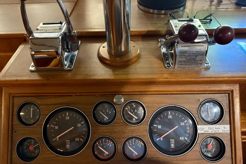 Slide: The Image of Control panel of a 1991 Grand Banks 42 Classic boat with gauges and levers. - 37