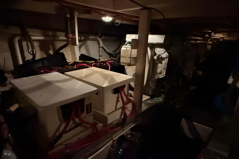 Slide: The Image of Engine room of a 1991 Grand Banks 42 Classic yacht, featuring mechanical components and wiring. - 110